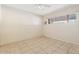 Bright bedroom features tile flooring and window for natural light at 9245 S 4Th Ave, Phoenix, AZ 85041