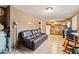 Living room with tile floors connects to kitchen, features leather sofa at 9245 S 4Th Ave, Phoenix, AZ 85041
