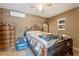 Bedroom with a ceiling fan, window for natural light, and ornate decor at 9245 S 4Th Ave, Phoenix, AZ 85041