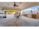 Outdoor kitchen with a built-in grill, dining area, and a covered patio with a ceiling fan for comfortable gatherings at 9245 S 4Th Ave, Phoenix, AZ 85041