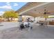 Covered patio with exercise equipment, dining table, BBQ grill, and mountain views, perfect for outdoor enjoyment at 9245 S 4Th Ave, Phoenix, AZ 85041