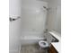 Clean bathroom featuring a shower over tub, white tiling, and neutral-toned flooring at 9318 E El Paso St, Mesa, AZ 85207