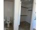 Bathroom featuring a toilet, walk-in closet, and handrails near the bathtub at 9318 E El Paso St, Mesa, AZ 85207