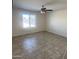 Bedroom with tile floors, ceiling fan, and a window providing natural light at 9318 E El Paso St, Mesa, AZ 85207