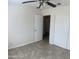 Neutral bedroom features tile floors, a ceiling fan, and a closet with sliding doors at 9318 E El Paso St, Mesa, AZ 85207