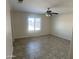 Well lit bedroom features a large window, tile floors and ceiling fan with lighting at 9318 E El Paso St, Mesa, AZ 85207