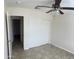 Bedroom with ceiling fan, closet, and tile flooring, ideal for a guest room or office at 9318 E El Paso St, Mesa, AZ 85207