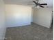 Spacious bedroom features neutral colored walls, tile flooring, and a ceiling fan with lights at 9318 E El Paso St, Mesa, AZ 85207