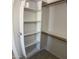 Walk-in closet featuring a shelving unit, closet rod, and tile flooring at 9318 E El Paso St, Mesa, AZ 85207