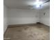 Clean garage featuring an automatic garage door opener and a side door at 9318 E El Paso St, Mesa, AZ 85207