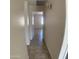 Hallway featuring neutral walls and flooring that connects to a bedroom with window at 9318 E El Paso St, Mesa, AZ 85207