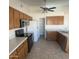 This kitchen features wood cabinets, stainless steel appliances, and a walk-in pantry at 9318 E El Paso St, Mesa, AZ 85207
