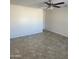 Spacious living room area features a neutral wall color, tile flooring and ceiling fan at 9318 E El Paso St, Mesa, AZ 85207