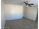 View of a bright living room with neutral walls, ceiling fan and tile flooring at 9318 E El Paso St, Mesa, AZ 85207