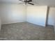 Spacious living room features tile floors, neutral color walls and a ceiling fan with lights at 9318 E El Paso St, Mesa, AZ 85207