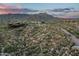 Beautiful aerial view of a desert landscape at dusk with a luxurious home nestled among the scenic mountains at 10020 E Relic Rock Rd # 18, Scottsdale, AZ 85262