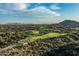 Scenic aerial view of a verdant golf course community surrounded by native desert vegetation and distant mountains at 10020 E Relic Rock Rd # 18, Scottsdale, AZ 85262