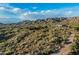 A panoramic aerial view reveals desert hillside homes against a mountain backdrop, showcasing natural desert landscaping at 10020 E Relic Rock Rd # 18, Scottsdale, AZ 85262