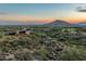 Expansive desert landscape with a golf course view and mountain views at sunset, creating a picturesque backdrop at 10020 E Relic Rock Rd # 18, Scottsdale, AZ 85262
