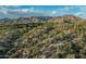 Desert landscape with native vegetation and modern-style homes, set against a stunning mountain backdrop at 10020 E Relic Rock Rd # 18, Scottsdale, AZ 85262