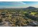 Expansive aerial view of a property featuring native landscaping, a golf course, and mountain views at 10020 E Relic Rock Rd # 18, Scottsdale, AZ 85262