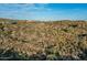 A scenic aerial showcases desert homes set in lush vegetation against a bright blue skyline at 10020 E Relic Rock Rd # 18, Scottsdale, AZ 85262
