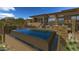 Stunning infinity pool featuring lounge chairs and lush landscaping creating a backyard oasis at 10020 E Relic Rock Rd # 18, Scottsdale, AZ 85262