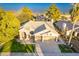 Aerial view of the home highlighting its lush landscaping, roof, and three-car garage at 10431 N 55Th Pl, Paradise Valley, AZ 85253