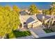 Aerial view of the home showcasing its landscaping, roof, and convenient three-car garage at 10431 N 55Th Pl, Paradise Valley, AZ 85253