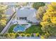 An aerial view showing a well-maintained backyard with a pool, lush greenery, and a covered patio at 10431 N 55Th Pl, Paradise Valley, AZ 85253