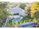 This aerial shot showcases a charming home with a pool, lush greenery, and a covered patio at 10431 N 55Th Pl, Paradise Valley, AZ 85253