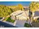 Aerial view showcasing the home's landscaping, roofline, and three-car garage at 10431 N 55Th Pl, Paradise Valley, AZ 85253