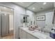 Bathroom features double sinks, a neutral color palette, and a shower with a shower curtain at 10431 N 55Th Pl, Paradise Valley, AZ 85253