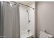 Updated bathroom showcases a tiled shower, a shower curtain, and modern fixtures at 10431 N 55Th Pl, Paradise Valley, AZ 85253