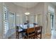 Sunlit dining area with views from ample windows features a dark table and matching chairs at 10431 N 55Th Pl, Paradise Valley, AZ 85253