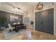 Elegant dining area with a modern chandelier, stylish furniture, and travertine flooring at 10431 N 55Th Pl, Paradise Valley, AZ 85253