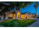 Beautiful single-story home featuring lush green lawn, mature trees, and a covered front entry at 10431 N 55Th Pl, Paradise Valley, AZ 85253