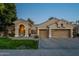 This beautiful home has a three-car garage, arched entryway, and a well-maintained front yard at 10431 N 55Th Pl, Paradise Valley, AZ 85253