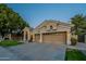 A beautiful home featuring a three-car garage, arched entryway, and manicured front lawn at 10431 N 55Th Pl, Paradise Valley, AZ 85253