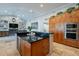 Kitchen with dark countertops, wood cabinetry, stainless steel appliances, and a view into the living area at 10431 N 55Th Pl, Paradise Valley, AZ 85253