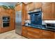 Close-up of a kitchen highlighting custom cabinets, stainless steel appliances, and stylish black countertops at 10431 N 55Th Pl, Paradise Valley, AZ 85253