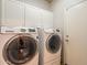 Well-equipped laundry room includes front load Samsung washer and dryer and plenty of storage at 10431 N 55Th Pl, Paradise Valley, AZ 85253