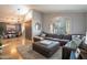 Comfortable living room featuring a large sectional sofa, shuttered windows and travertine flooring at 10431 N 55Th Pl, Paradise Valley, AZ 85253