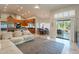 Bright living area boasts vaulted ceilings, and sliding glass doors opening to the patio and a kitchen with wooden cabinets at 10431 N 55Th Pl, Paradise Valley, AZ 85253