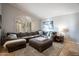 Bright living room with a comfortable sectional sofa, shuttered windows, and travertine flooring at 10431 N 55Th Pl, Paradise Valley, AZ 85253