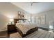 Comfortable main bedroom with a tray ceiling, a dark wood bed frame, soft carpet, and bright shuttered windows at 10431 N 55Th Pl, Paradise Valley, AZ 85253