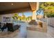 Outdoor covered patio showcasing a built-in barbecue, tiled flooring, and backyard views at 10431 N 55Th Pl, Paradise Valley, AZ 85253