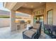 Relaxing outdoor living with a covered patio featuring a built-in grill and comfortable seating area at 10431 N 55Th Pl, Paradise Valley, AZ 85253