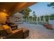 Serene patio view highlighting outdoor seating, tiled flooring, and a glimpse of the backyard and pool at 10431 N 55Th Pl, Paradise Valley, AZ 85253