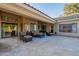 Expansive covered patio with stylish outdoor seating, tiled flooring, and easy access to the backyard at 10431 N 55Th Pl, Paradise Valley, AZ 85253